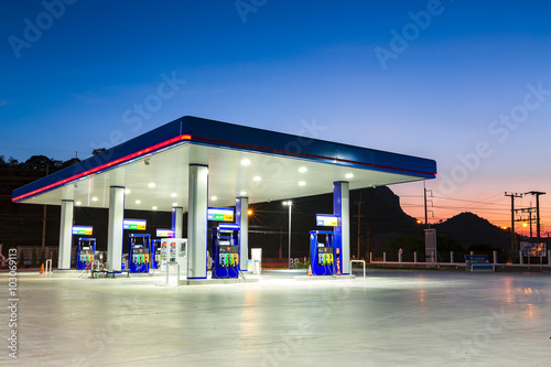 Fotografie, Obraz Gas station at sunset.