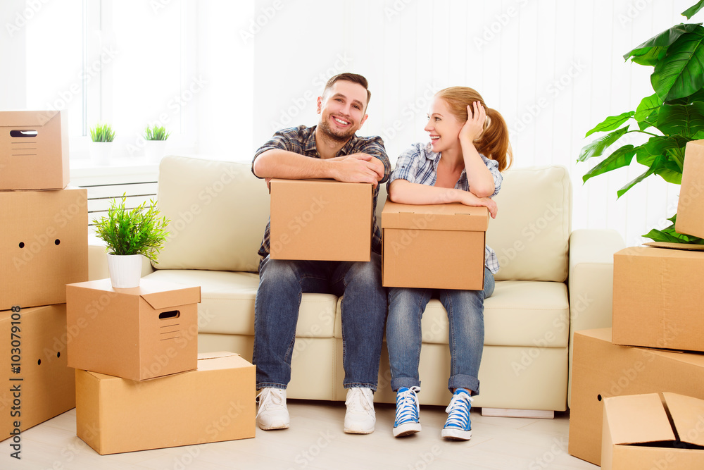 moving to a new apartment. Happy family couple and cardboard box moving to a new apartment. Happy family couple and cardboard box