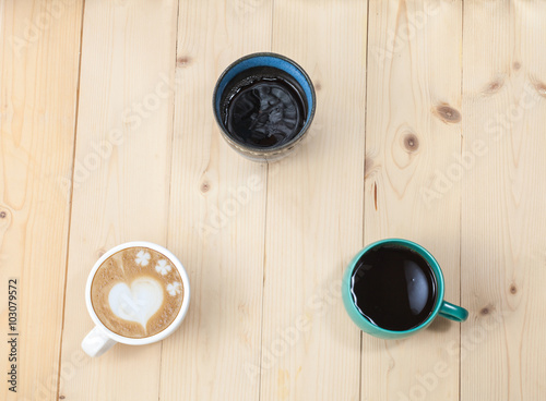 Hot drink ,black coffee ,late art,tea in mug on wood table