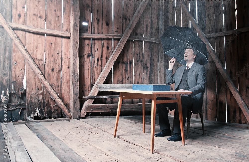 Businessman with Feet on Table Holding Umbrella is Waiting for Better Business Businessman with Feet on Table Holding Umbrella is Waiting for Better Business