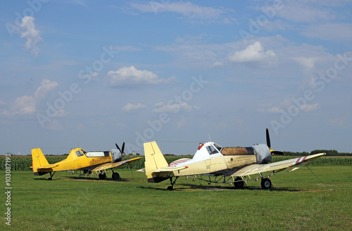 crop duster airplanes on airfield