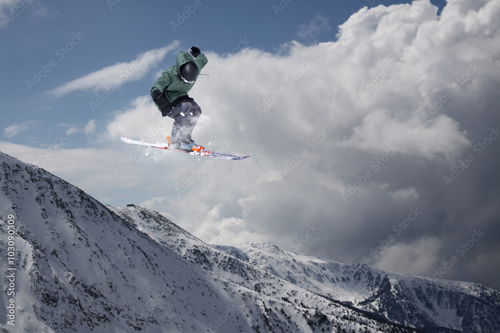 Flying skier on mountains. Extreme sport. Flying skier on mountains. Extreme sport.