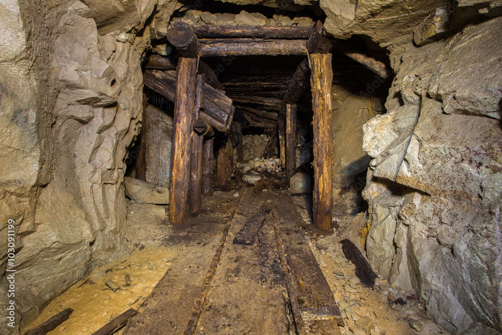 Old abandoned gold mine tunnel passage with yellow sulfur dirt Old abandoned gold mine tunnel passage with yellow sulfur dirt