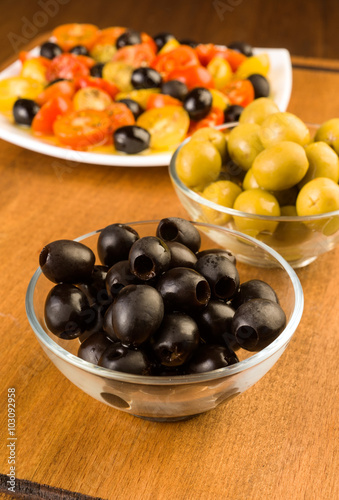 green and black olives in glass bowl