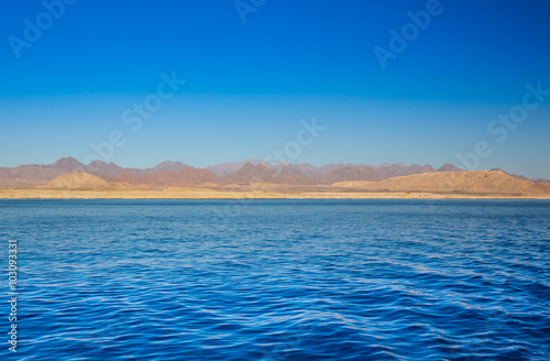 View on red mountains from the sea