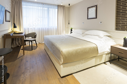 Interior of a double hotel bedroom in the morning