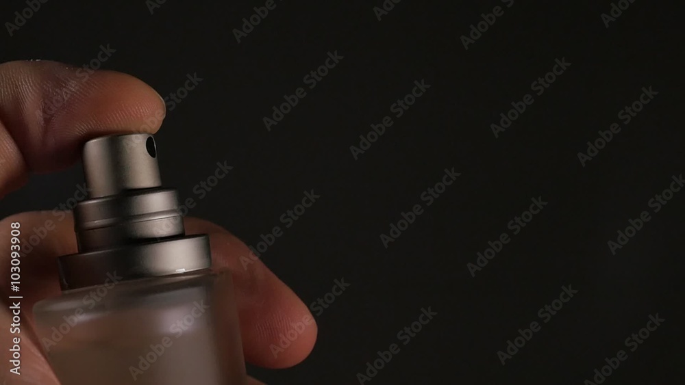 Fragrance  luxury bottle contents in dark spraying slow motion 1080p FullHD video - Perfume bottle spary on black background 1920X1080 slow-mo footage