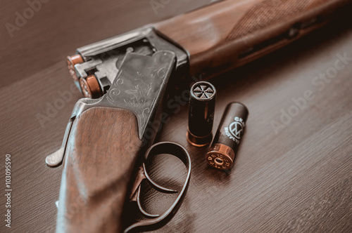 Hunting rifle on a wooden background