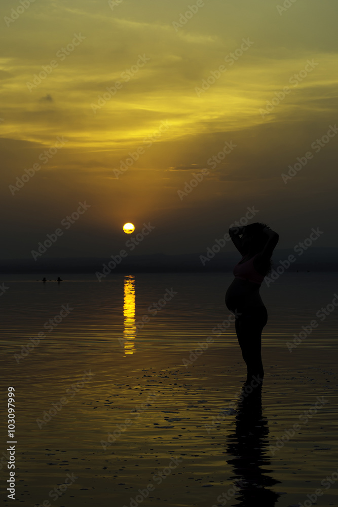 pregnant at sunset.