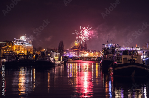 AMSTERDAM, NETHERLANDS - JANUARY 1, 2016: Festive salute of fireworks on New Year's night. On January 1, 2016 in Amsterdam - Netherland. photo