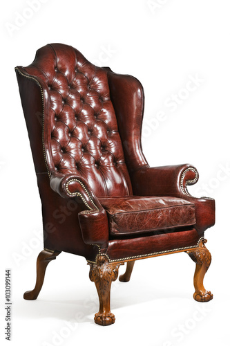 antique leather wing chair carved legs isolated