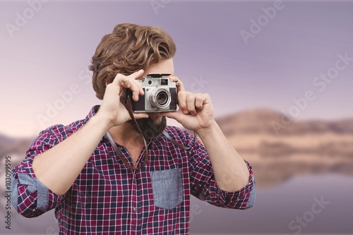 Composite image of hipster photographing with camera photo