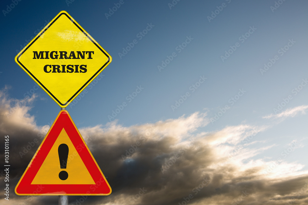 Road signs Attention Migrant Crisis on a background with dramatic sky Road signs Attention Migrant Crisis on a background with dramatic sky