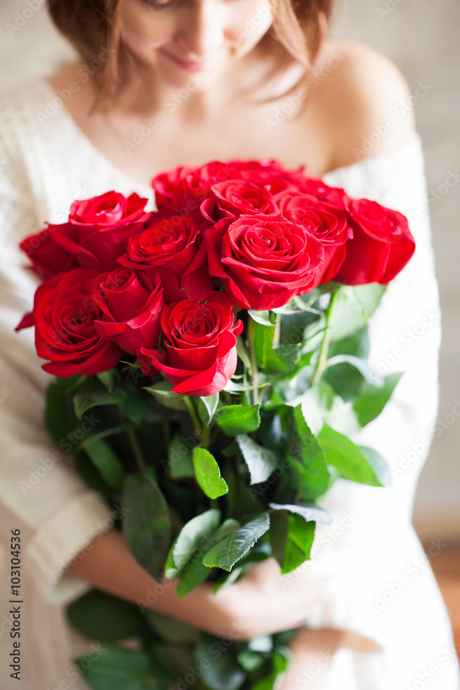 beautiful girl with big red roses bouquet