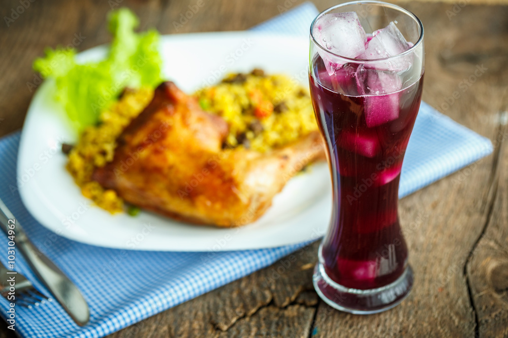 Tasty dishes from chicken thigh with rice and lettuce and a glas Tasty dishes from chicken thigh with rice and lettuce and a glas