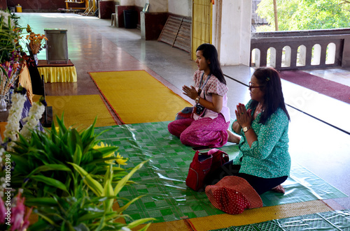 Thai people praying buddha statue at Chedi Buddhakhaya photo