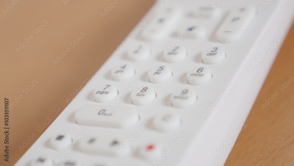 Shallow depth of field white remote control for TV buttons close-up tilt 4K 2160p 30fps UHD footage - Slow tilting over contemporary RC gadget 4K 3840X2160 UltraHD video Shallow depth of field white remote control for TV buttons close-up tilt 4K 2160p 30fps UHD footage - Slow tilting over contemporary RC gadget 4K 3840X2160 UltraHD video