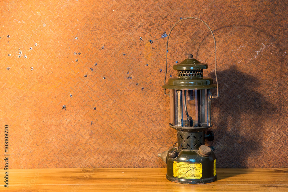 Still life art photography concept with oil lantern on old  stee