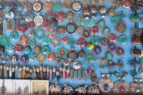 Various of different colorful Tibetan pendulums with sacred symbols in the shop at market in leh, India