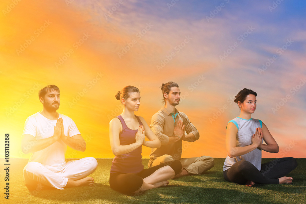 The group of people doing yoga exercises The group of people doing yoga exercises