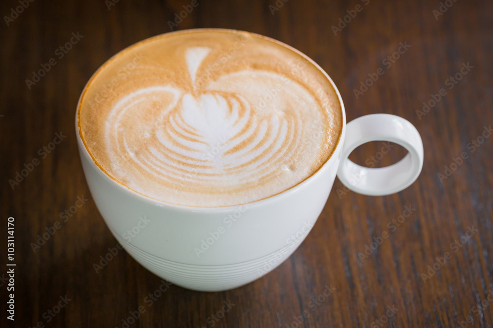 cup of latte art coffee on wooden background cup of latte art coffee on wooden background