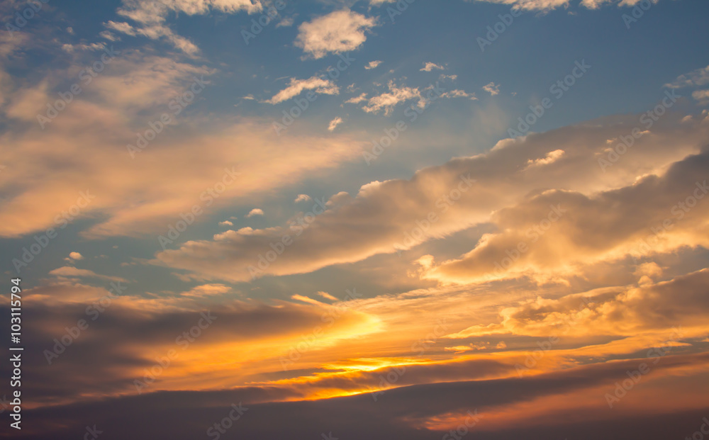 Blue, beautiful sky with white, orange, puffy clouds