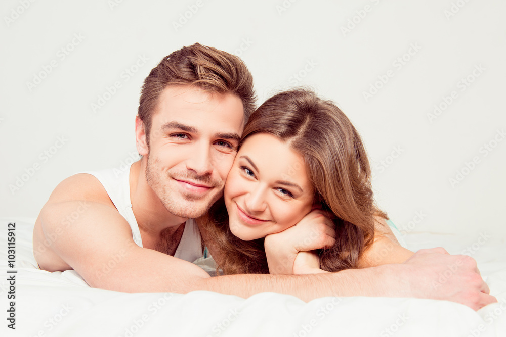 Close up portrait of happy cute couple in love on bed Close up portrait of happy cute couple in love on bed