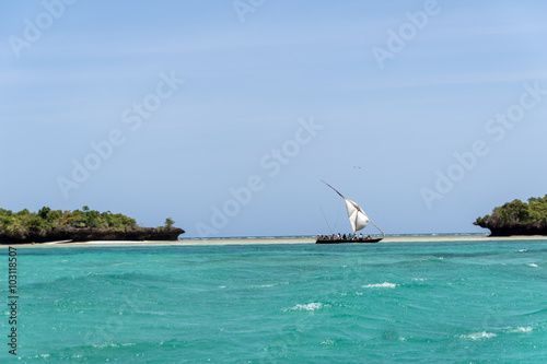 Local wooden boat sailing the Indian Ocean off the coast of Tanzania photo