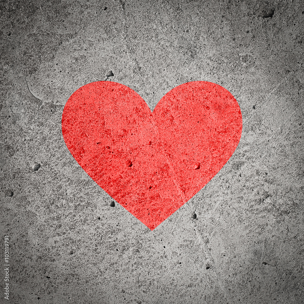 Painted red heart on dark grey grunge concrete and cement wall, textured background