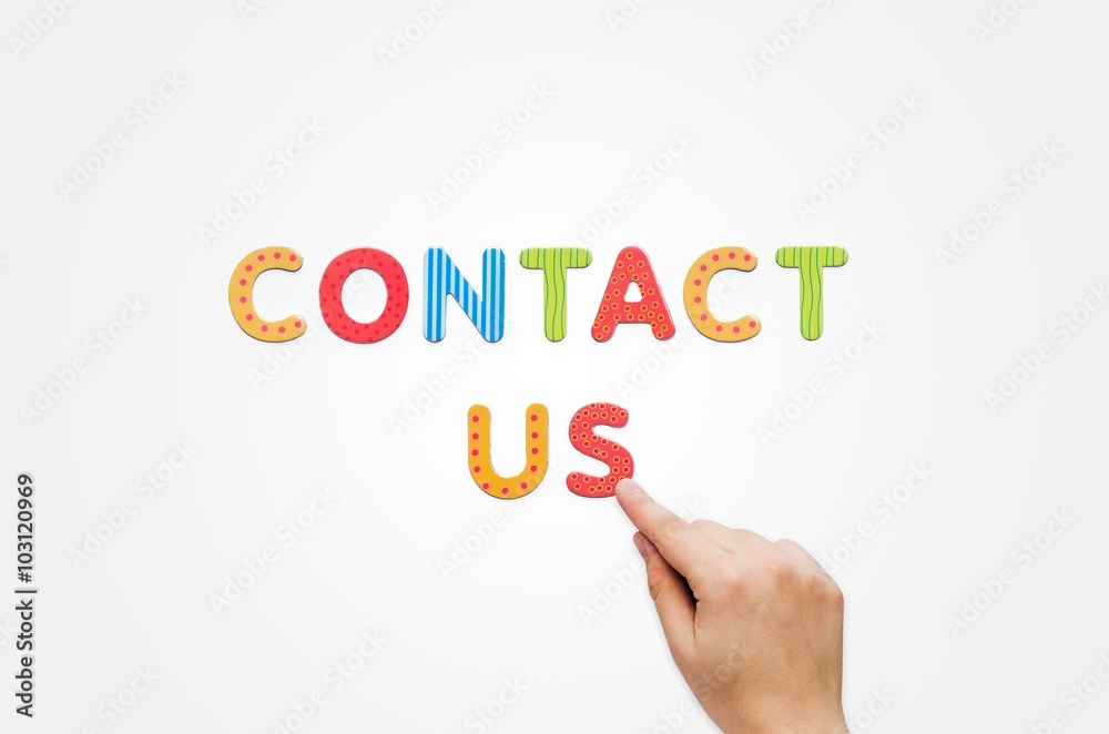 Hand put the words Contact Us with magnetic letters Hand put the words Contact Us with magnetic letters
