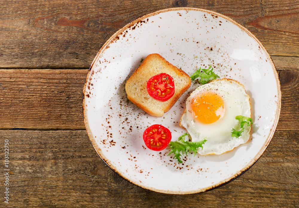 Breakfast with egg, toast and fresh tomatoes. Breakfast with egg, toast and fresh tomatoes.