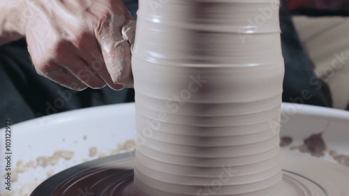 	Pottery sculpting a traditional clay pot, close up, tracking shot