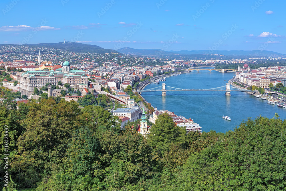 View of Budapest from Gellert Hill, Hungary. The image shows Buda Castle, Danube with Szechenyi Bridge and Margaret Bridge, Hungarian Parliament Building.