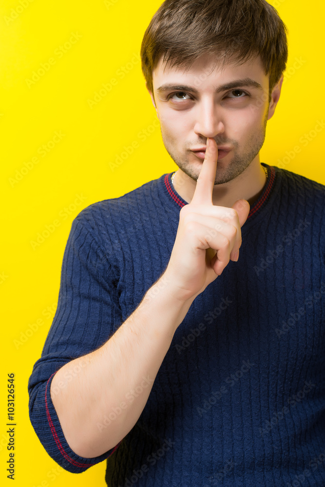 Shhhh - quiet, silence, secret gesture, young handsome man