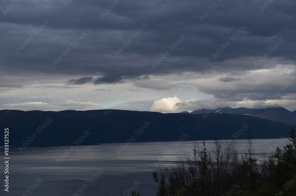 Mountain lake Torneträsk on a cloudy evening