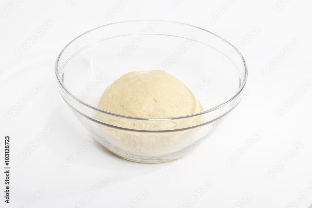 ball of raw dough over white background