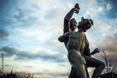 AMSTERDAM, NETHERLANDS - JANUARY 1, 2016: Ancient bronze statue in park of The Rijksmuseum (Netherlands national museum dedicated to arts and history in Amsterdam).  Amsterdam - Netherland. photo