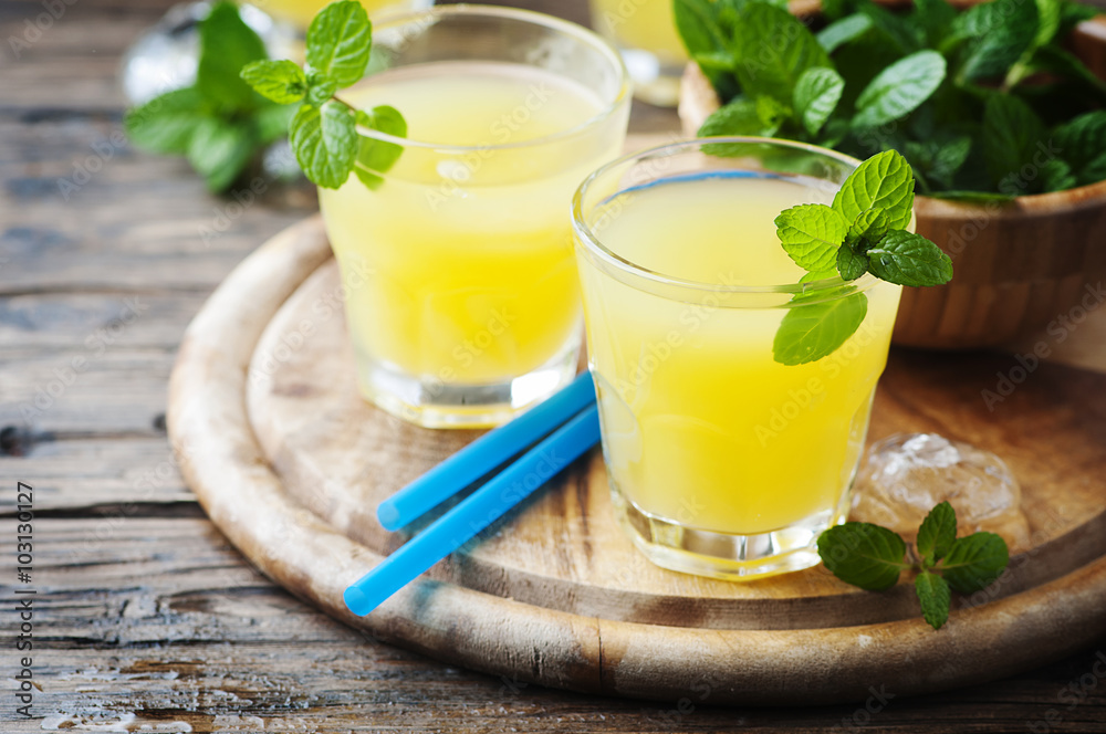 Yellow fresh cocktail with mint and ice