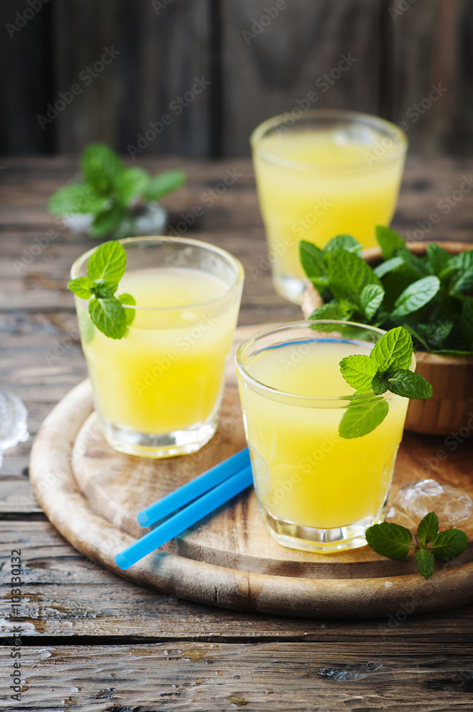 Yellow fresh cocktail with mint and ice Yellow fresh cocktail with mint and ice