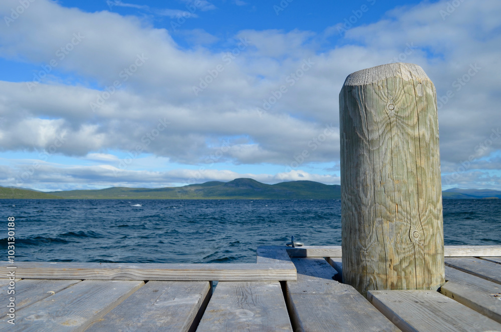 Εκτύπωση καμβά Wooden pier in the blue lake Torneträsk, subarctic Swedish Lapland