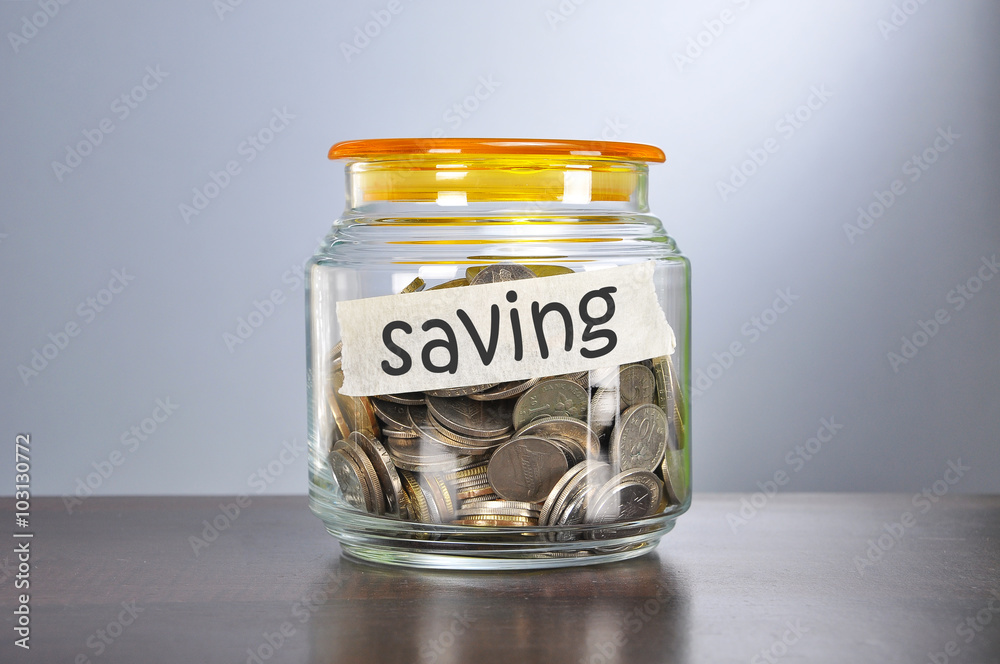 Saving concept of coins in the glass jar for saving purpose Saving concept of coins in the glass jar for saving purpose