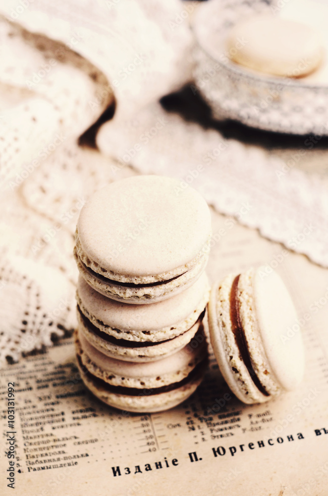 Pile of vanilla macaroons with chocolate ganache, retro style