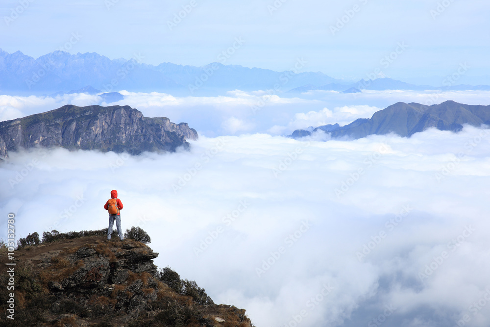 young woman hiker enjoy the view on mountain peak