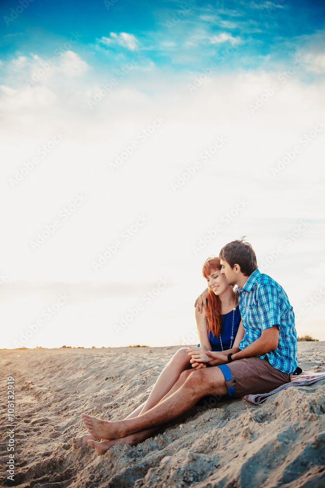  a young couple enjoys a mid summer late afternoon, on a wet san