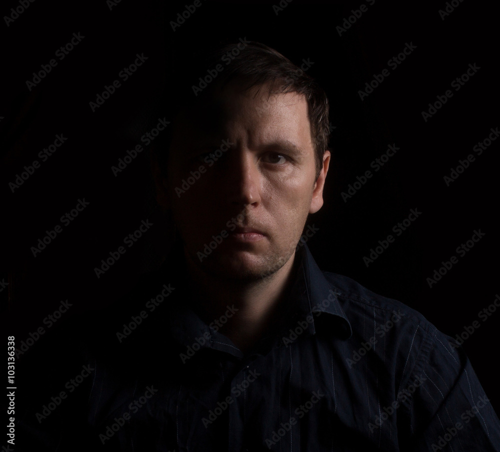 Dramatic portrait of a man in a low key. People Dramatic portrait of a man in a low key. People