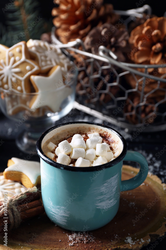 Mug of hot cacao with marshmallow and cookies on black table Mug of hot cacao with marshmallow and cookies on black table