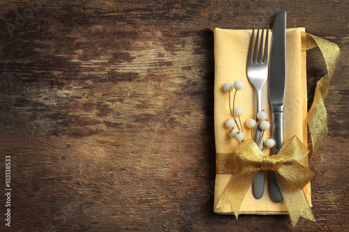 Christmas serving cutlery with napkin on a wooden background