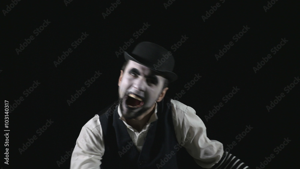Young hilarious scary crazy evil mime making funny faces Young hilarious scary crazy evil mime making funny faces