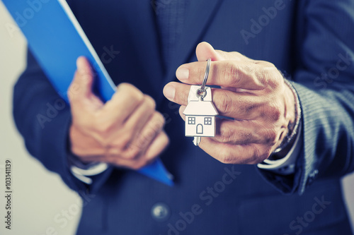 Hand with a house key  photo