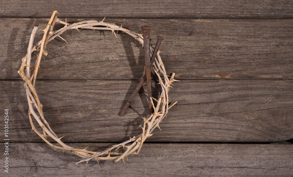 Crown of Thorns and Nails on a Rustic Wooden Surface